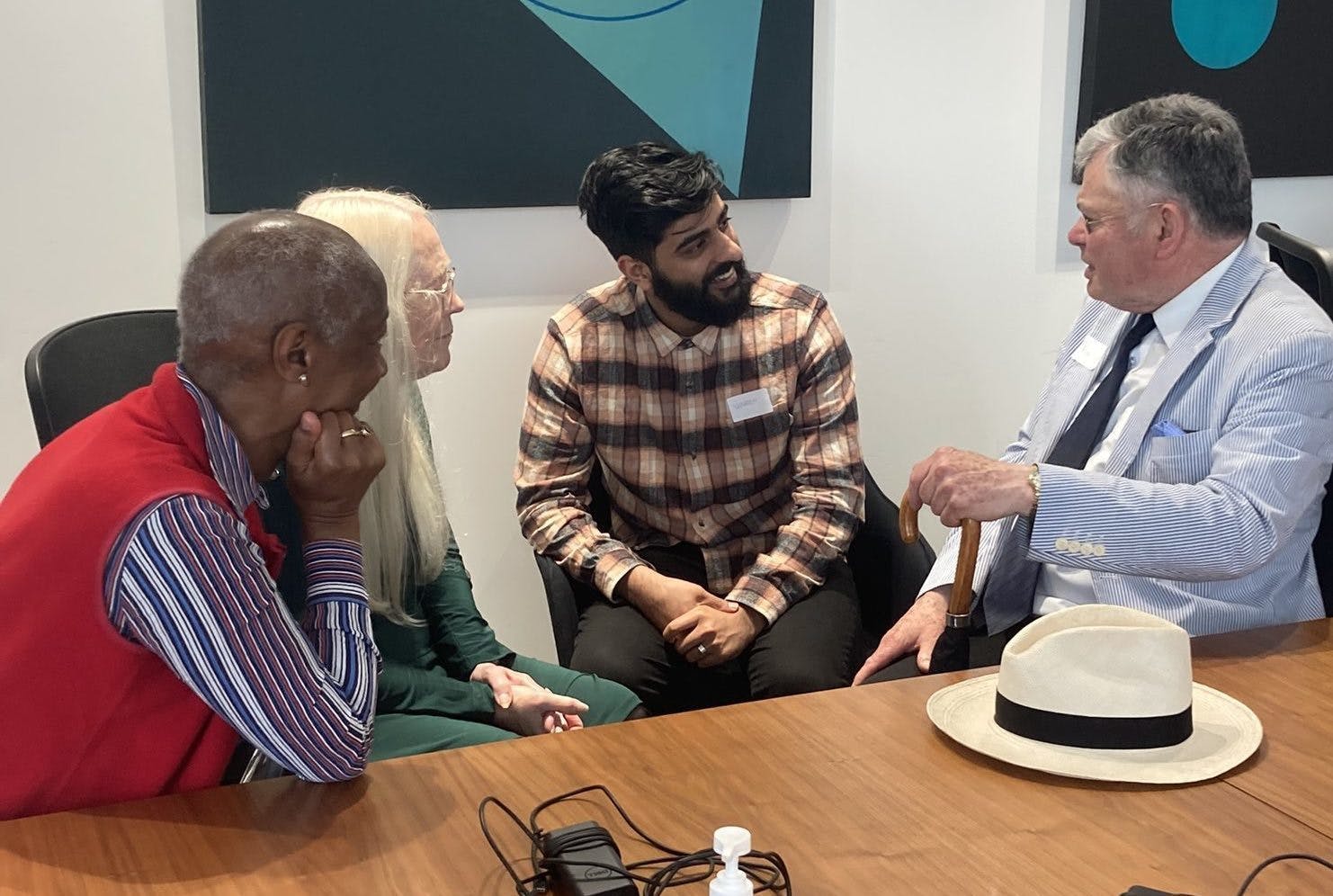 A group of neighbours sitting at a table in conversation