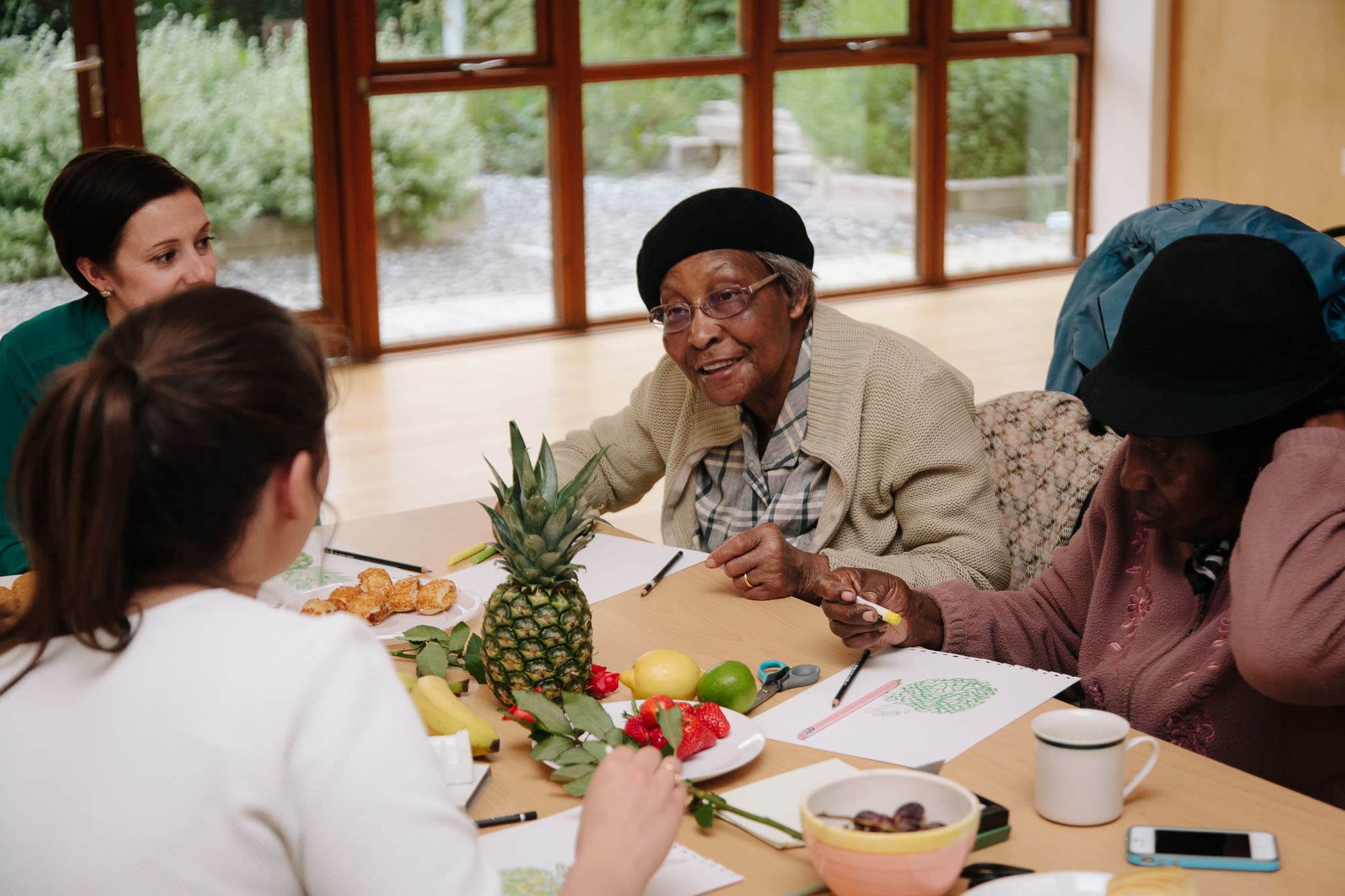 Women having a conversation with fruit on the table