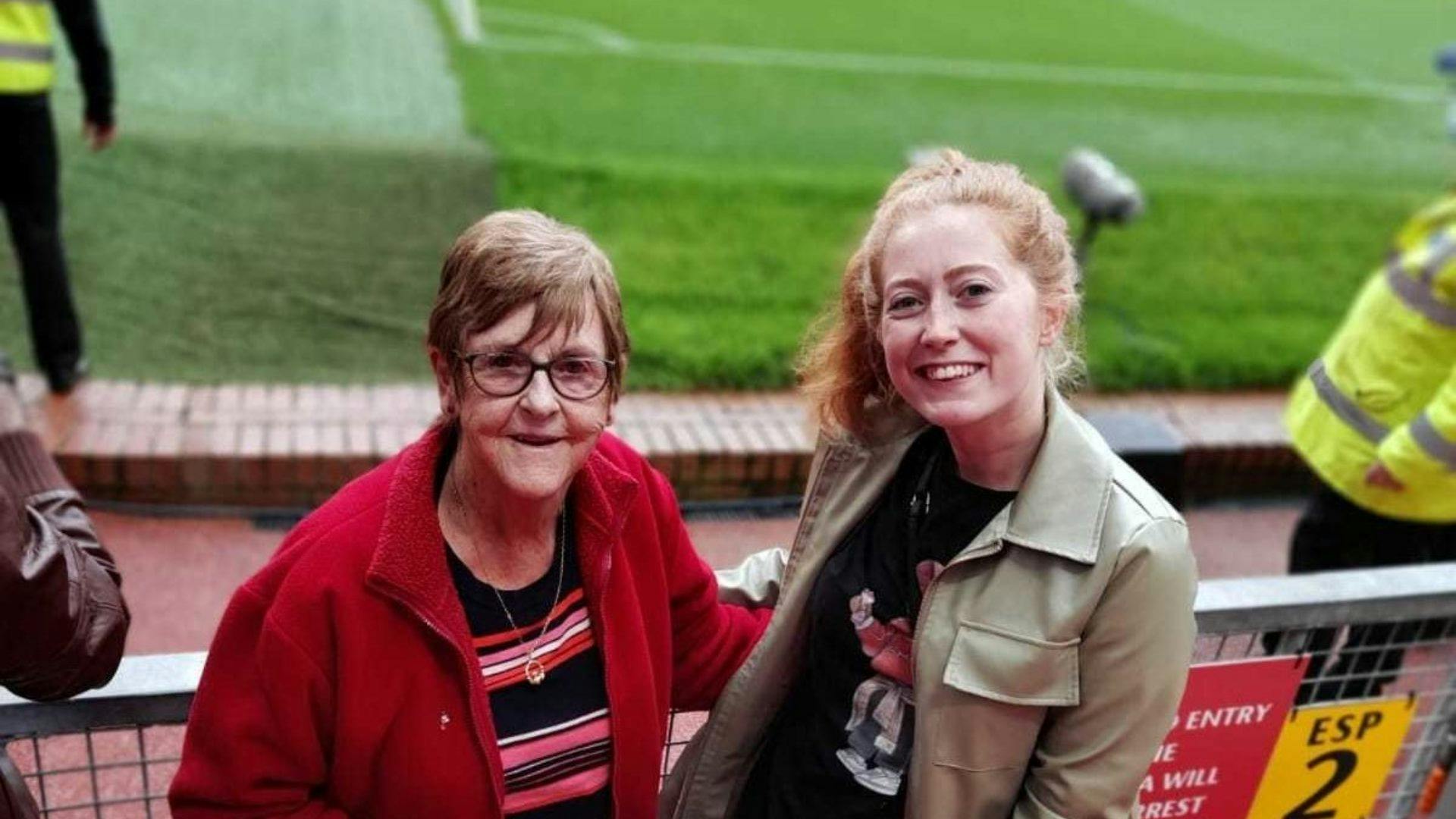 An older and younger neighbour at a football match