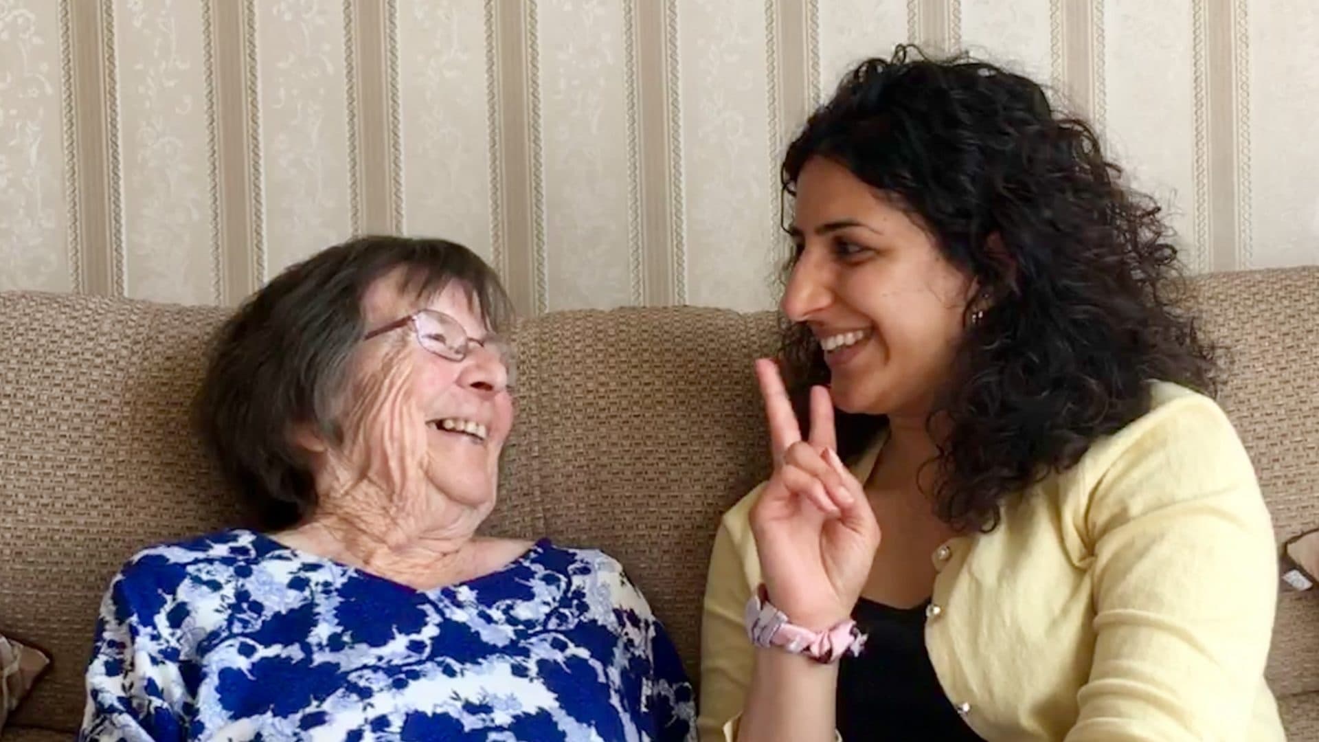 Two women smiling at each other